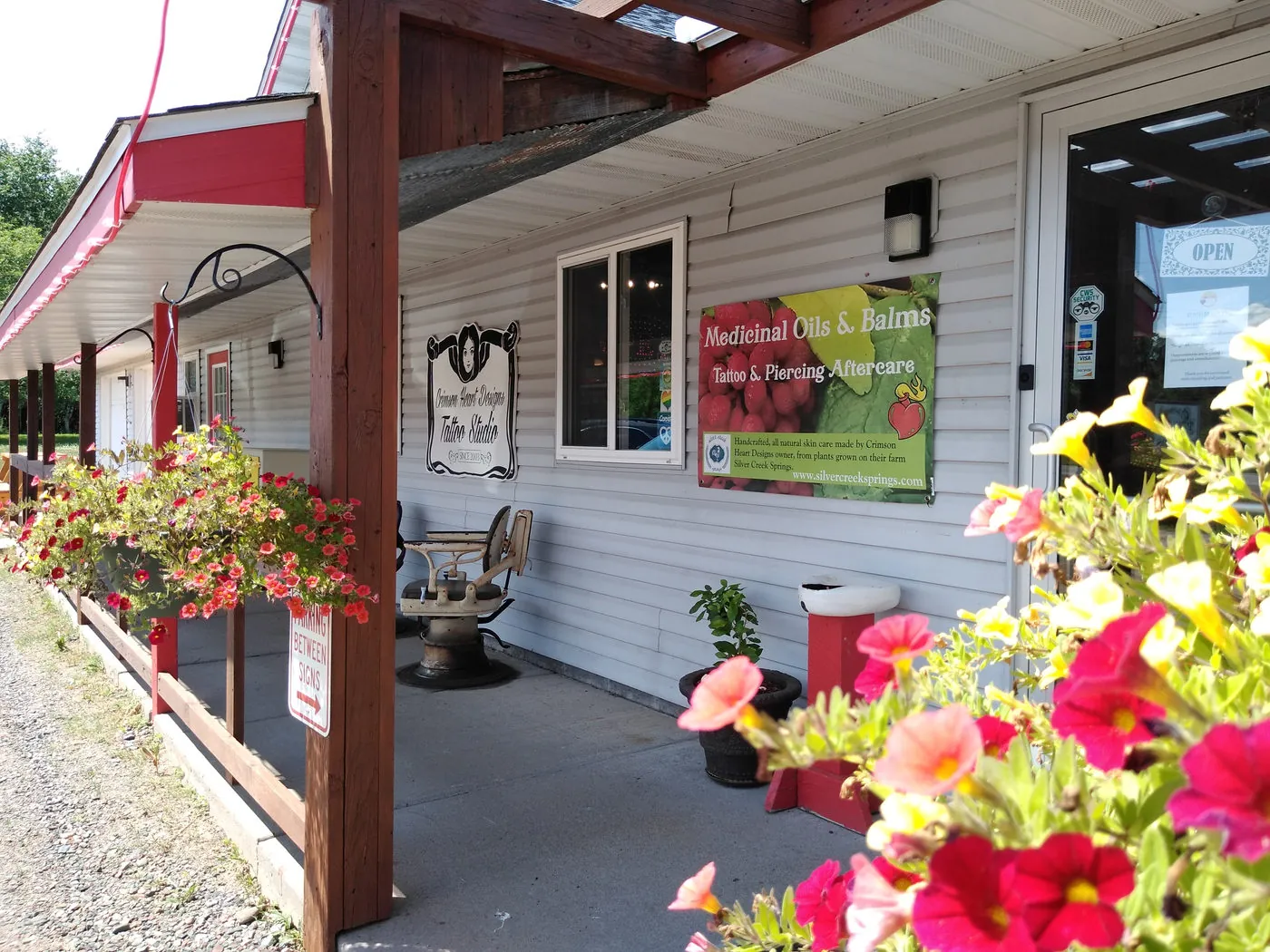 Flower baskets on the studio's front porch